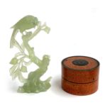 A painted treen cylindrical box, 8.5cmD, together with a carved jadeite figure of a bird on a branch