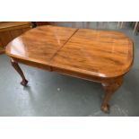 A 20th century walnut veneer extending dining table by Epstein, with spare leaf and winder, with