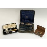 A cased silver vanity set, comprising button hook, tweezers, nail scissors, etc, all with chased