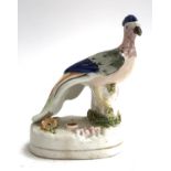 A 19th century Staffordshire figural pen holder in the form of a fancy bird, with encrusted detail