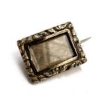 A Georgian gold cased lace pin with engraved detail, the glazed locket containing woven blonde hair,
