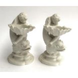 Two 19th century bisque porcelain table salts (af), in the form of cherubs and dolphins, bearing