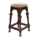 A high quality mahogany leather and close nailed circular stool, on carved and tapered legs,