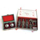A boxed set of Chinese Baoding balls together with a cased set of miniature 'terracotta' warriors,