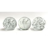 A pair of large art glass orb paperweights, together with one other, each approx. 12.5cmD