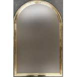 A 20th century domed wall mirror in a heavy tubular gilt metal frame, 94x62cm