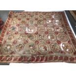 A very large rug, comprising 30 floral panels (significant damage), 327x350cm