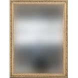 A large rectangular wall mirror with bevelled glass within a gilt gesso picture frame, approx.