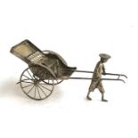 A white metal figure of a man pulling a rickshaw, stamped, 20cmL