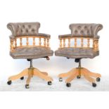A pair of contemporary Italian grey vinyl and beech captains swivel office chairs, button