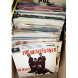 A box of 7 inch singles to include The Beatles and Jake the peg etc. Together with a small