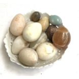 A lot of 12 mineral specimen eggs, to include marble, in a pierced ceramic bowl