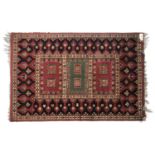 A red ground rug with three central rectangles, 188x126cm