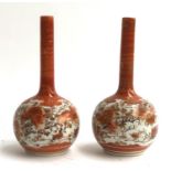 A matched pair of Japanese Kutani bottle vases decorated with birds amongst flowers, marked to base,