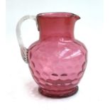 A 19th century hand blown cranberry glass jug with clear glass handle, 19.5cmH