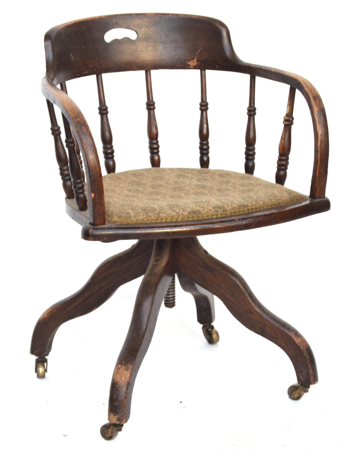 An early 20th century oak adjustable swivel office chair, on brass casters, 54cmW