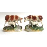 A pair of Staffordshire cow figures (af), 13.5cmH
