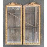 A pair of gilt gesso pier mirrors, one with violin cresting, the other with vacant cartouche, each