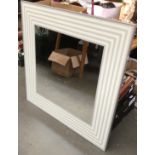 A modern wall mirror with frosted border, 97x97cm