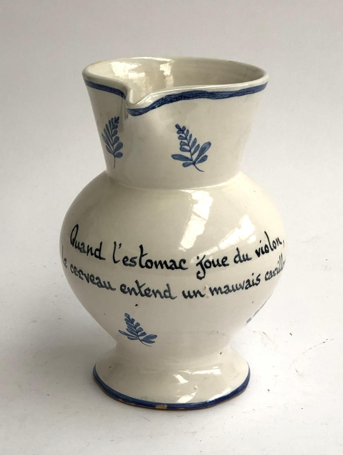 A French faience jug, hand painted with blue floral motifs and the motto 'Quand l'estomac joue du - Image 2 of 2