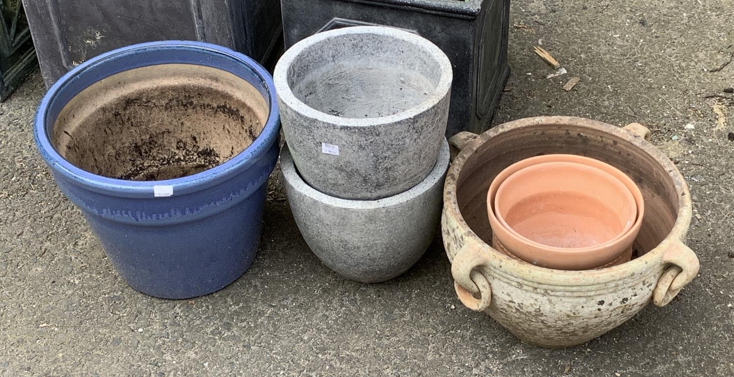 A quantity of plant pots, some terracotta, the largest 33cmD