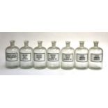 A set of seven vintage Italian chemists glass bottles, all with stoppers, each 26cmH