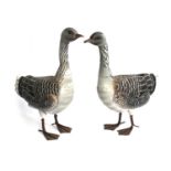 A pair of painted metal geese sculptures, each approx. 53cmH