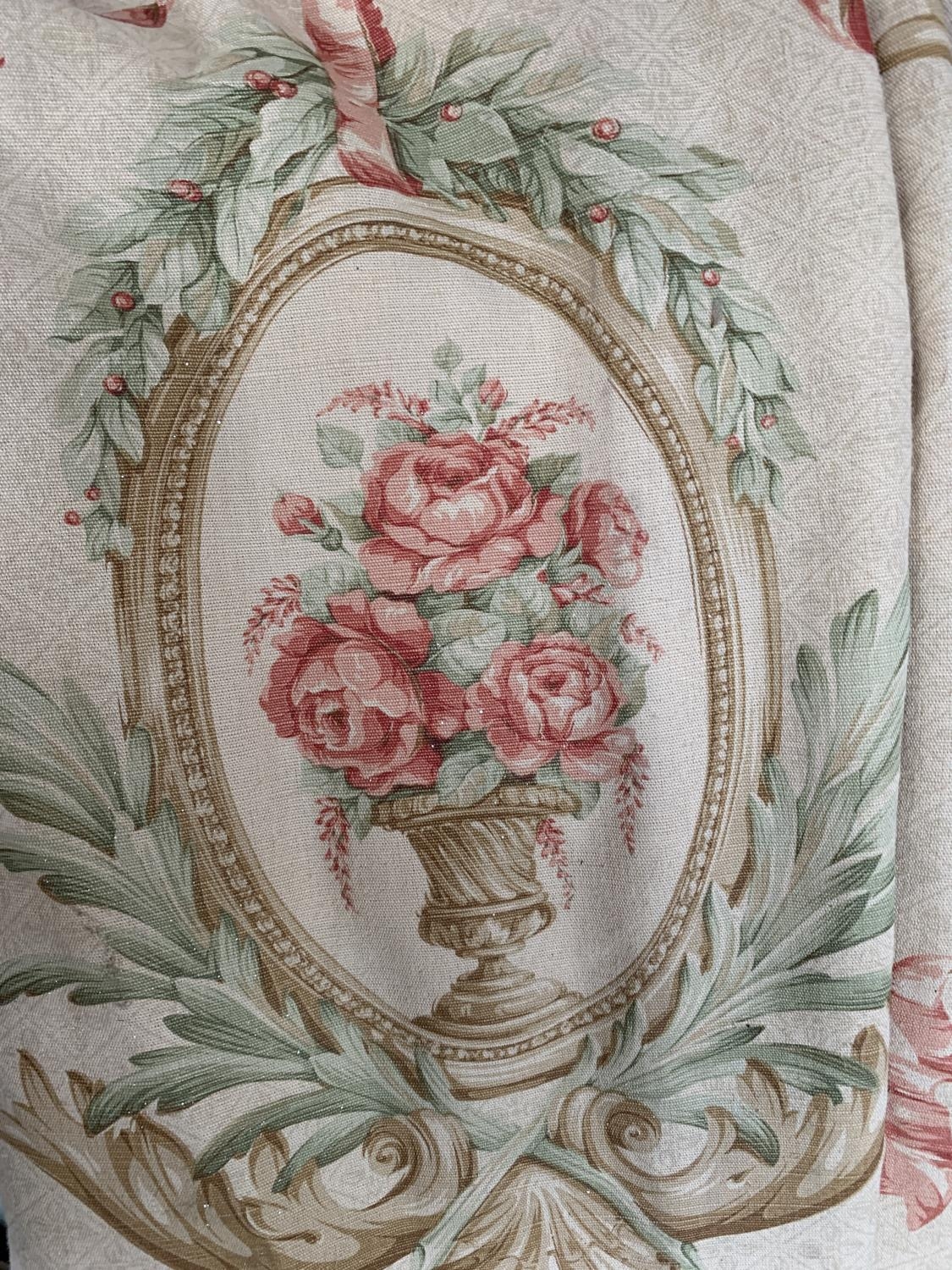 A pair of curtains, repeating design of pink roses within a foliate cartouche, lined and interlined,