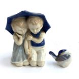 A Carl Schneider Erben porcelain figure of two children underneath an umbrella, 12.5cmH; together