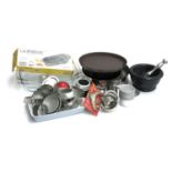 A mixed lot of kitchenalia to include biscuit cutters; flan dishes; cake tins; tart cases etc