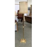 A gilt metal reeded standard lamp, with shade, on a square base, approx. 163cmH to top of shade