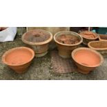 Four large terracotta plant pots to include a near pair with lizard design, the largest pot 57cmD