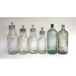 A graduating set of chemists jars, the tallest 38cmH; together with two large bottles impressed '