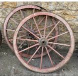 A pair of 12 spoke wooden wagon wheels with metal rims, 113cmD