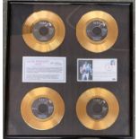 A framed and glazed set of four special edition gold plated Elvis Presley records, comprising 'In