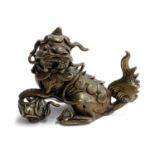 A Chinese bronze foo dog holding a ball beneath paw, 7cmH