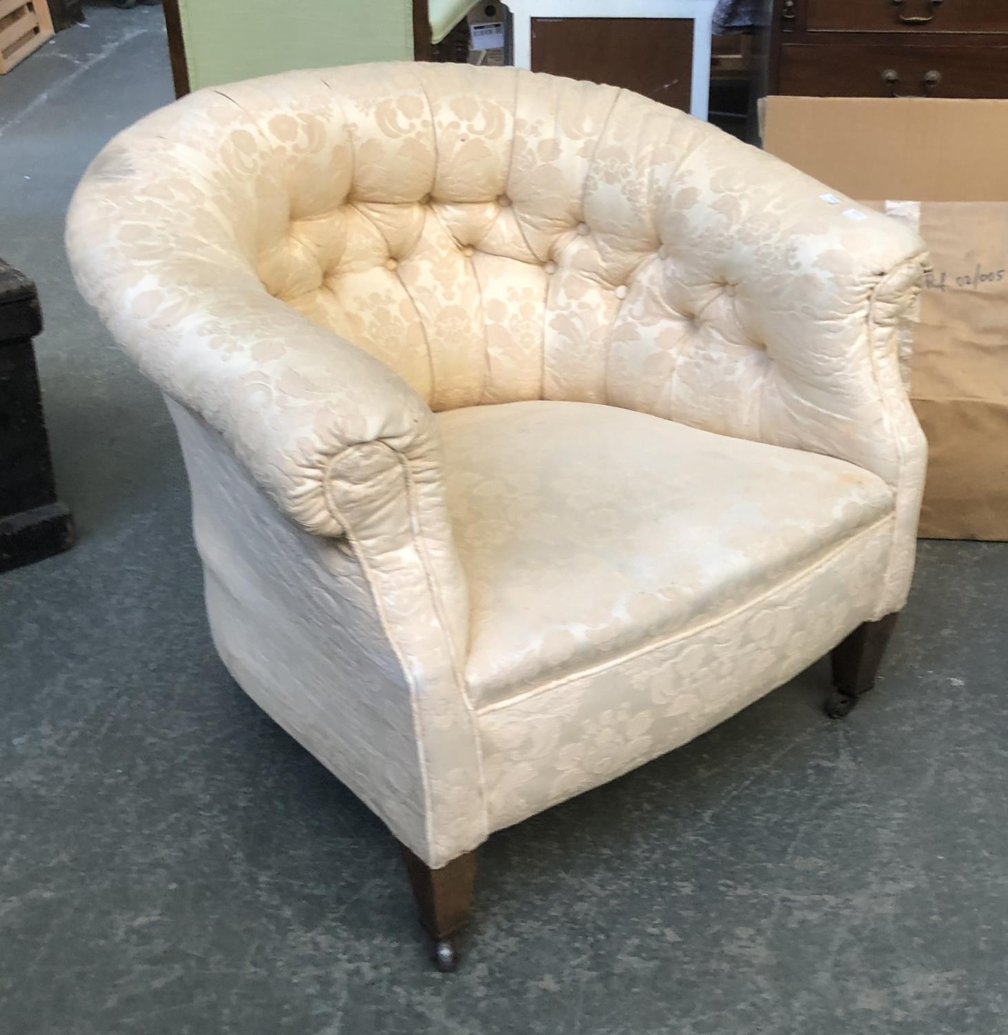 An early 20th century deep buttonback tub chair, on square tapered legs and casters, 91cmW approx.