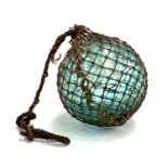 A blue glass fishermans float with original netting, approx. 16cmD