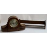 A large oak cased mantel clock, 55cmW; together with an oak book rack, 65cmW (2)