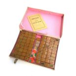 An early 20th century Chinese bakelite Mahjong set, boxed, with instructions