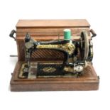 A Singer sewing machine serial no. 12755088 in oak case