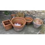 A quantity of mainly terracotta plant pots, the largest 48cmD