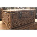 A wicker picnic hamper with contents