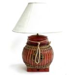 A Chinese red painted and cane table lamp, with white shade, 52cmH to top of shade