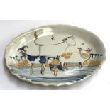 A large majolica stoneware charger decorated with farm animals, 44.5cm