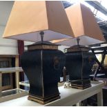 Interior design interest: a pair of square baluster form table lamps in black and gilt, with lion