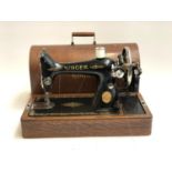 A Singer sewing machine in domed oak carry case, serial no. Y2293437