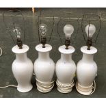 A set of four white ceramic baluster form table lamps, 32cmH to base of fitting