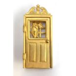 A vintage Jonette Jewellery brooch in the form of a door opening to reveal a dog chasing a cat,