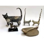 A large studio pottery cat (leg repaired), 33cmL; together with a pair of wooden cats; a resin